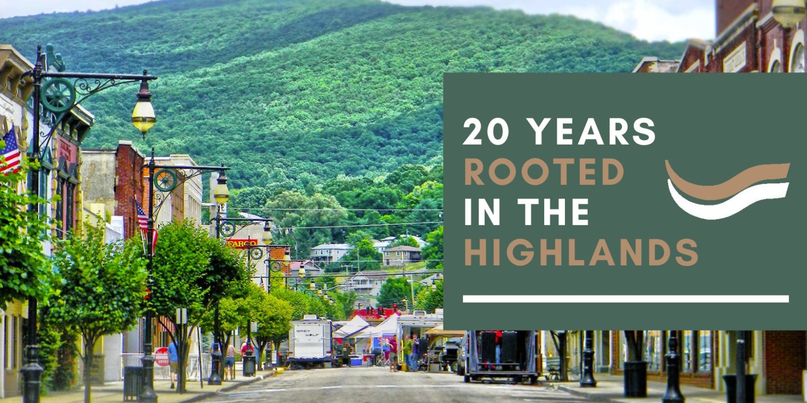 Photo of historic city street in front of a tree-covered mountain with the words 