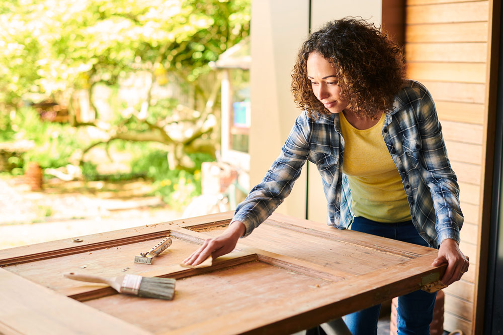 young woman working on home renovations