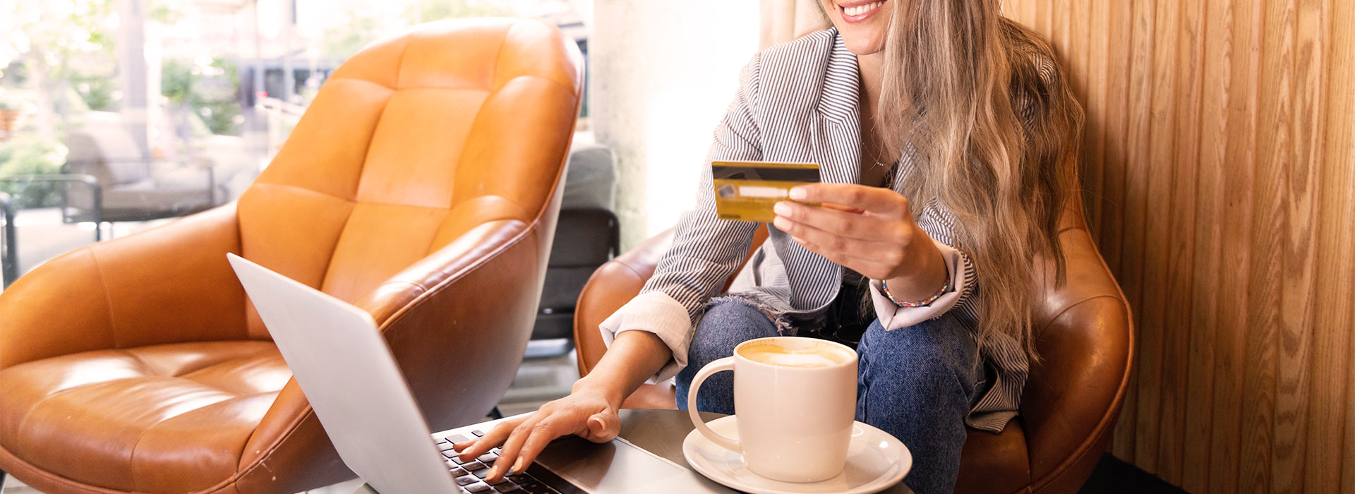 woman using credit card on laptop