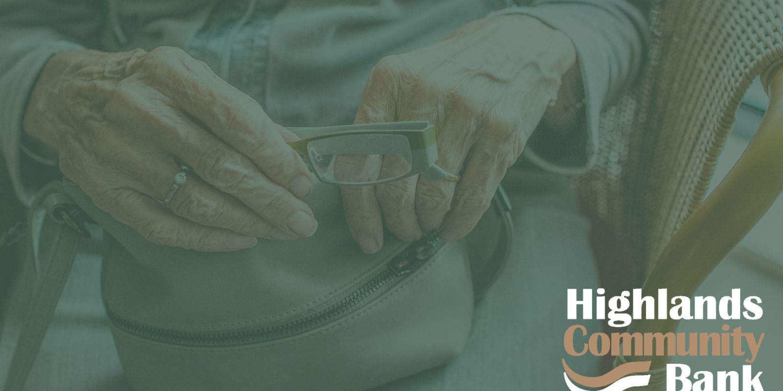 Green filtered photo of hands holding a pair of glasses. Highlands logo is in the corner