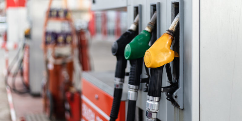 up close shot of three gasoline pistols at a gas pump