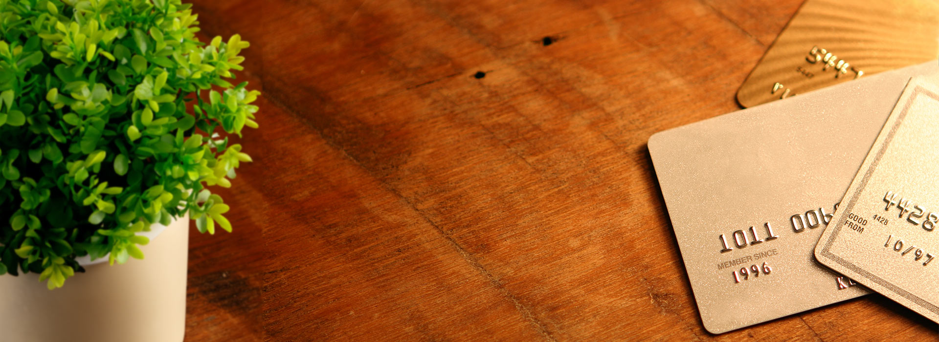several credit cards on a wooden table